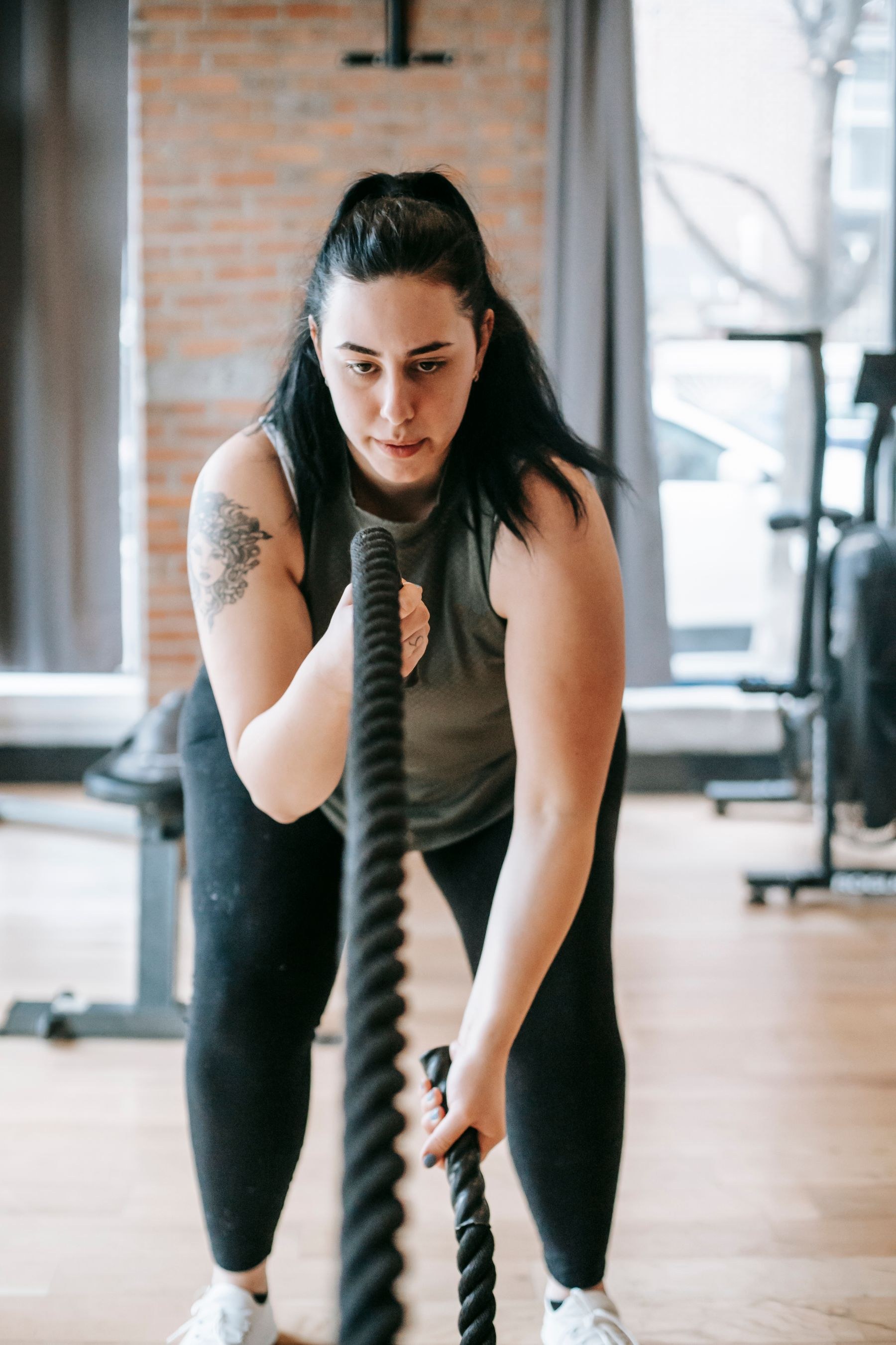 A woman exercising with a battle rope