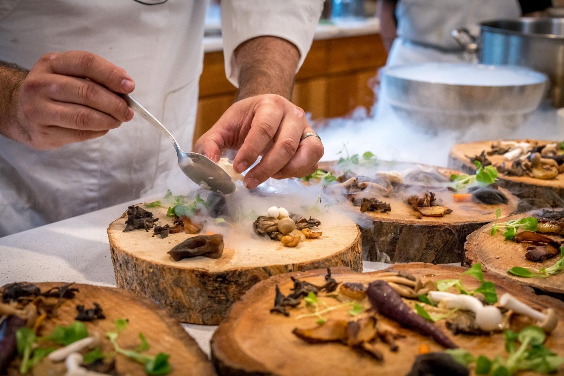 A chef arranging fresh food for a gathering