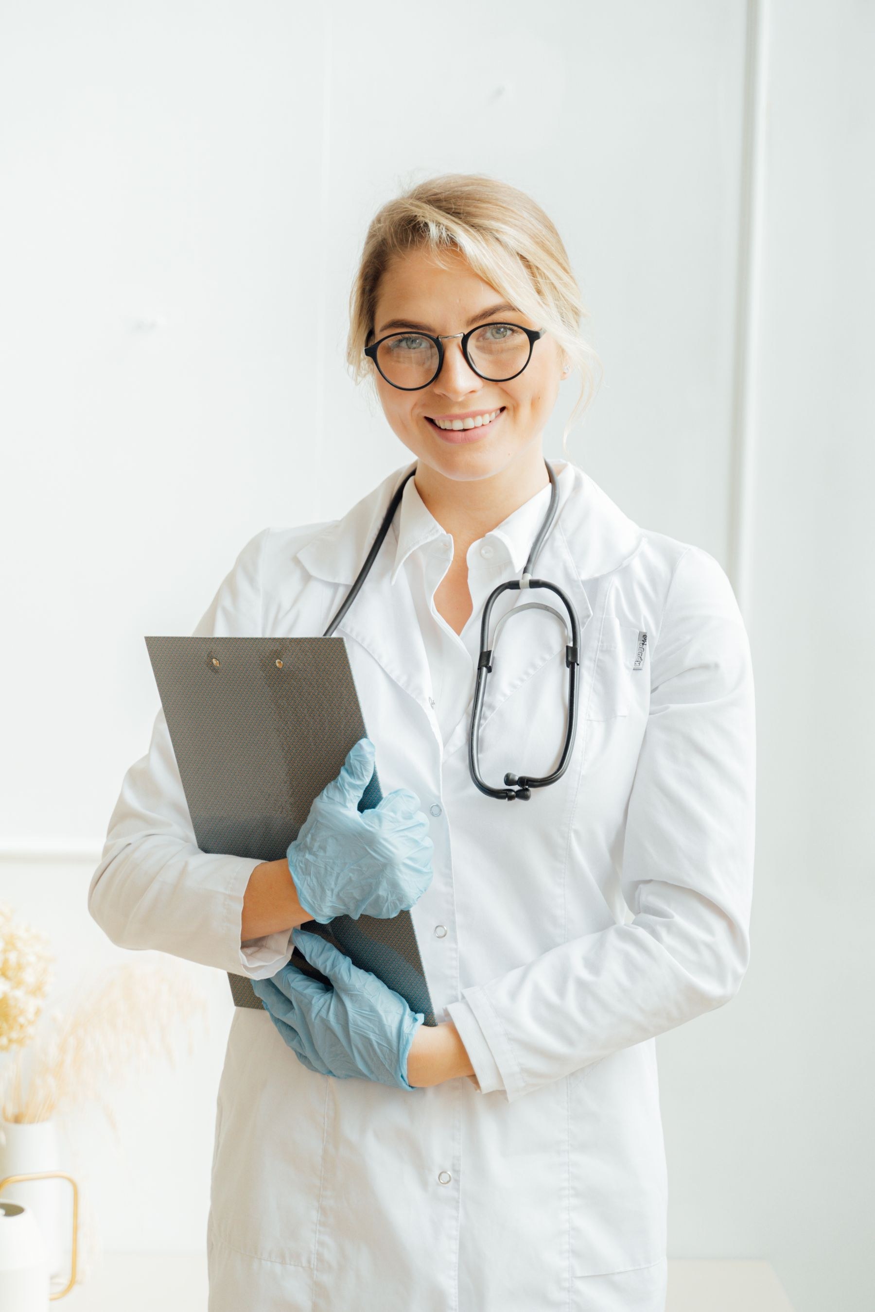 A clinical professional holding a consultation clipboard