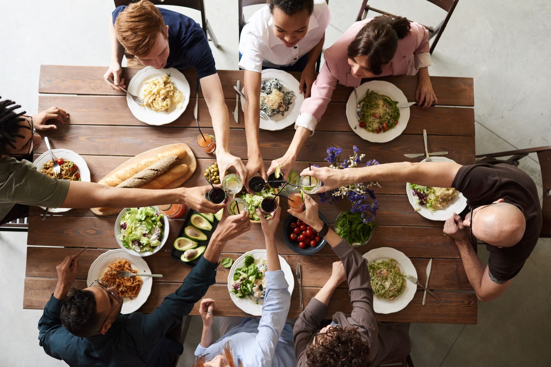 Friends sharing a fresh meal around a communal table